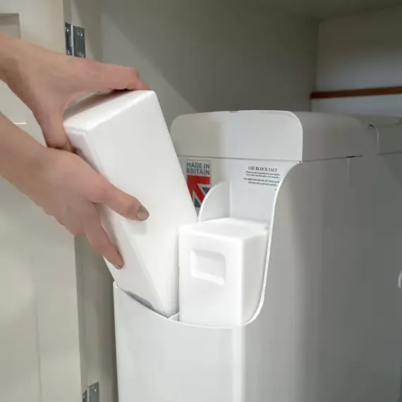 Inserting a salt block into a water softener