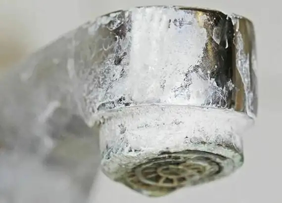Crusty limescale buildup on a tap