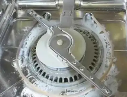 Limescale build-up at the bottom of a dish washer